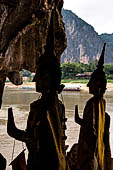 Luang Prabang, Laos - The Pak Ou Caves, the lower cave called Tham Ting. The caves, a Buddhist pilgrimage site, are a repository of old Buddha statues. 